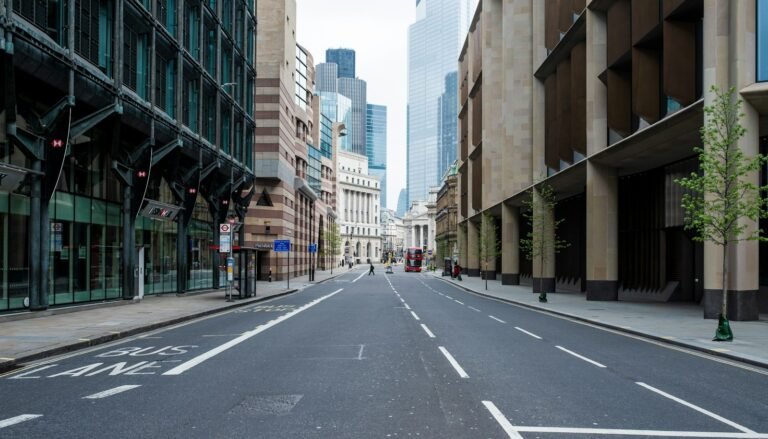 Empty road between high rise buildings