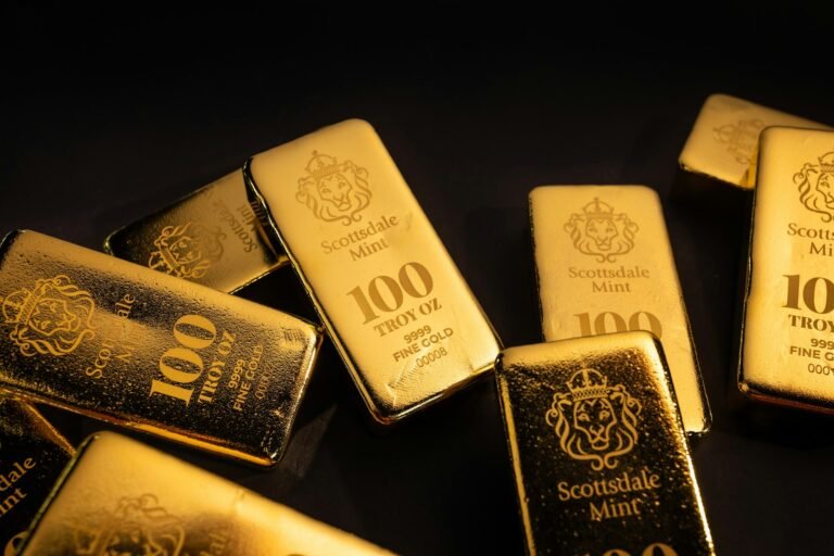 Several gold bars scattered on a dark surface