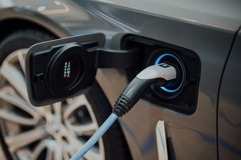 Electric vehicle charging cable plugged into car